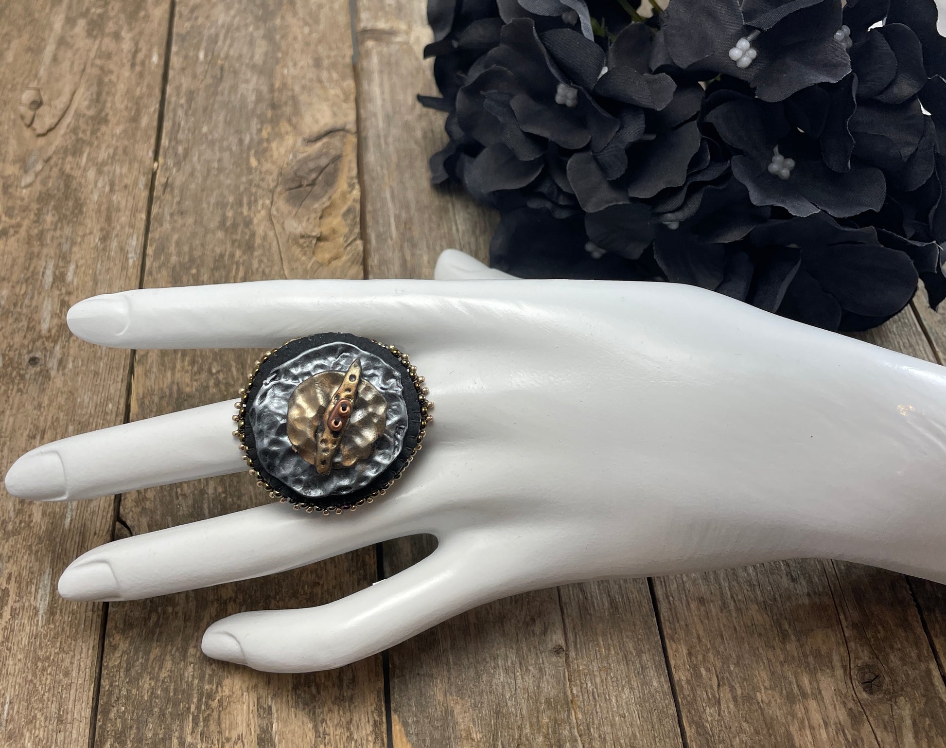 Round statement ring with abstract hammered copper and silver clay with dark gold beaded edge