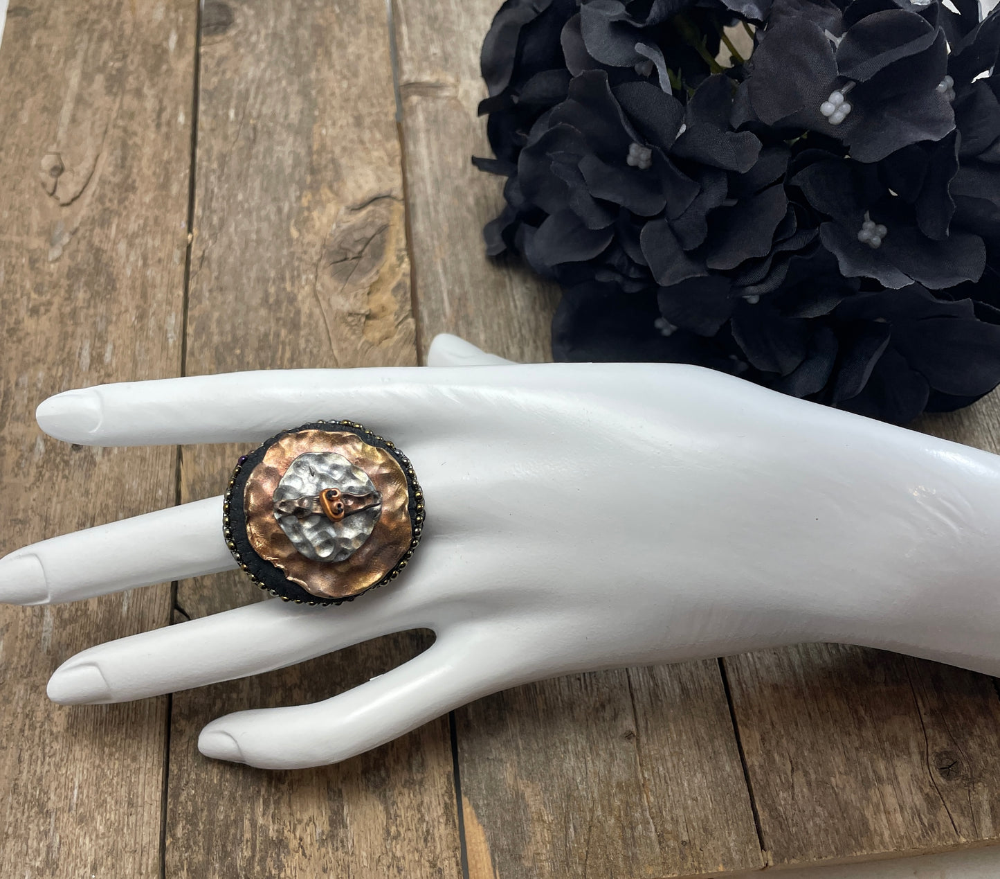 Round statement ring with abstract hammered copper and silver clay with dark gold beaded edge