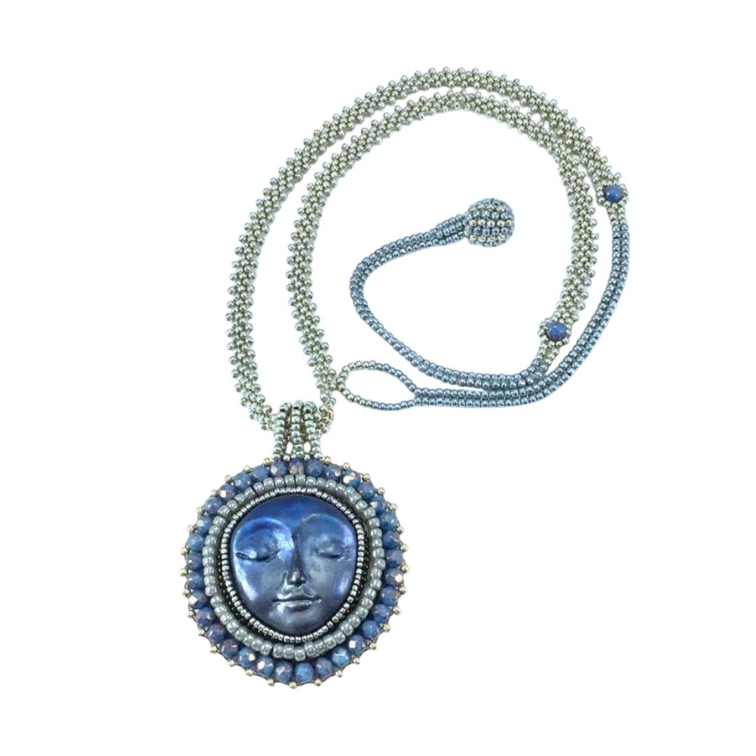 Necklace with a blue pendant featuring a face design on a white background