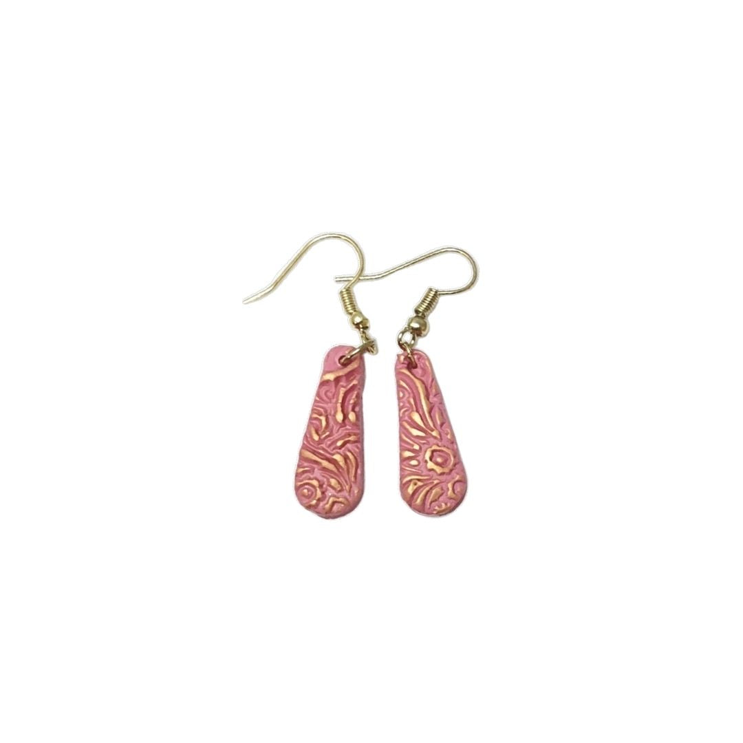 Pink teardrop clay earrings against a white background