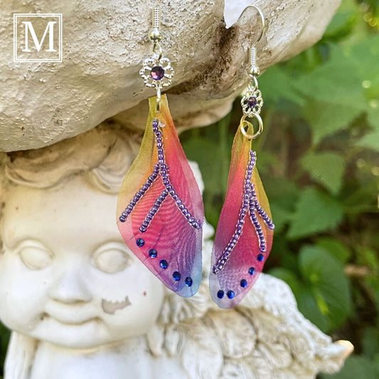 Colorful rainbow sheer fabric  with beading and blue crystals. A flower bead with a crystal connects the wings to the ear wires.