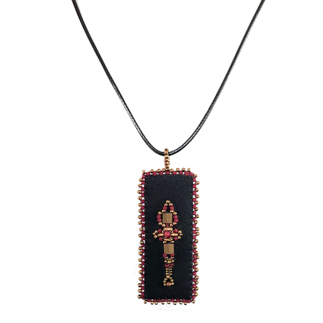 Red and Gold Beaded faux leather rectangle pendant with beaded edge.