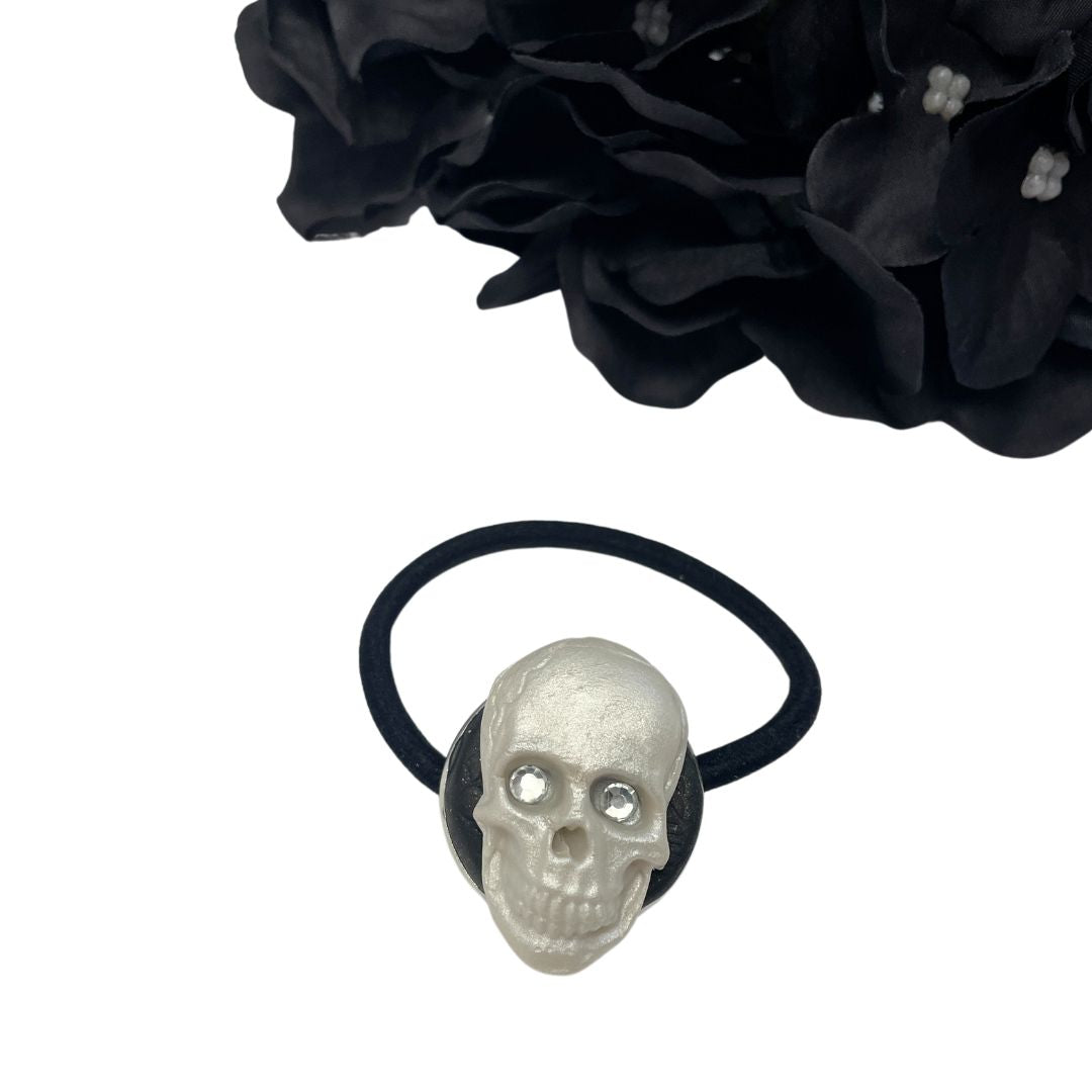 Decorative Hair tie with polymer clay Skull with crystal eyes on a white background with black hydrangeas