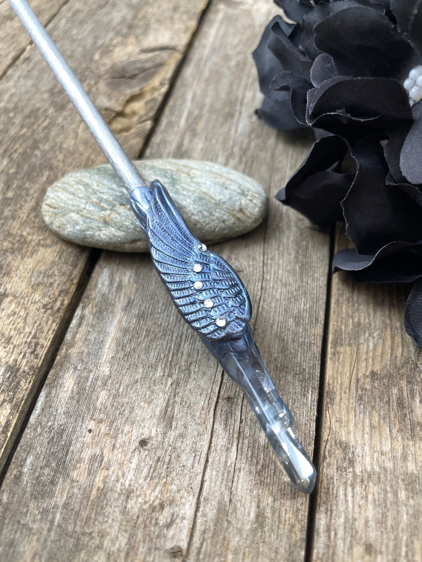 Silver blue hair stick with crystal angel wing detail with a raw crystal