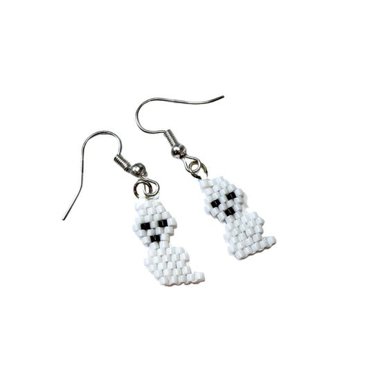 Handmade beaded ghost dangle earrings on black earring card, white and black seed beads
