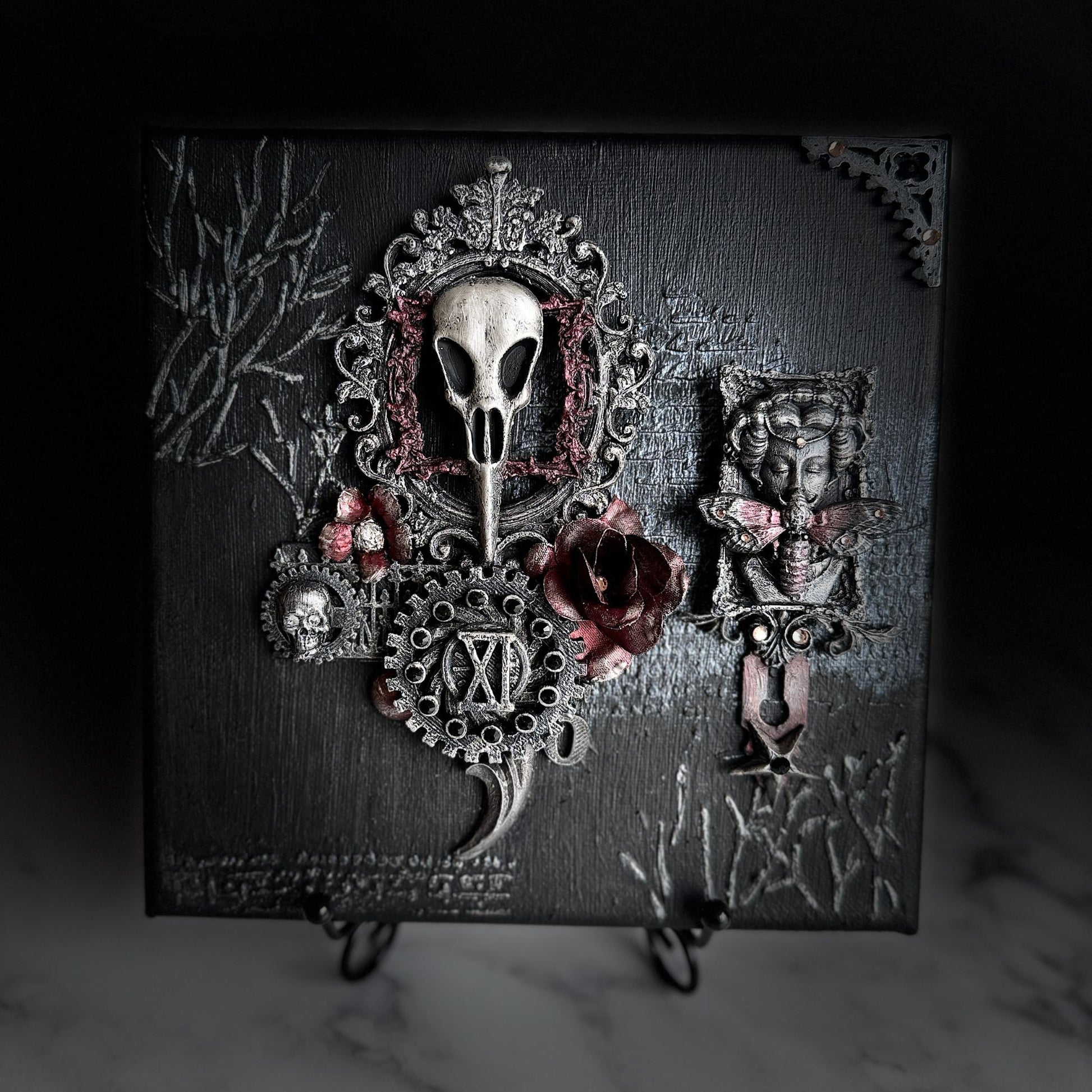 Decorative piece with skull and floral design on a dark background
