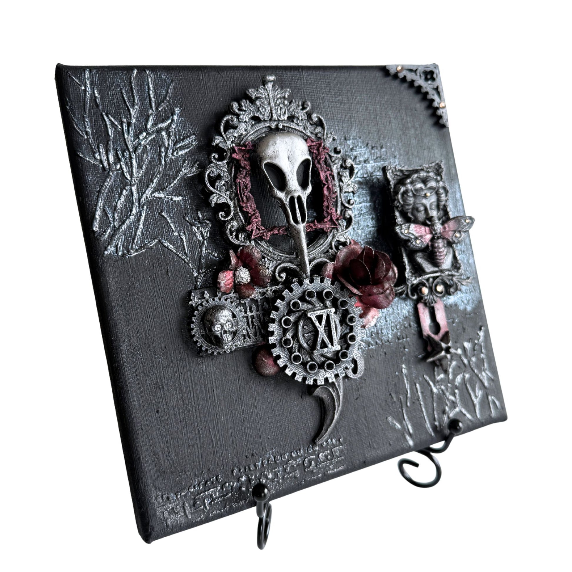 Decorative wall hook with skull and floral design on a dark background