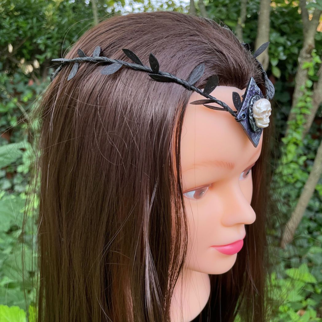 Skull black leaf wire crown resting on a model.