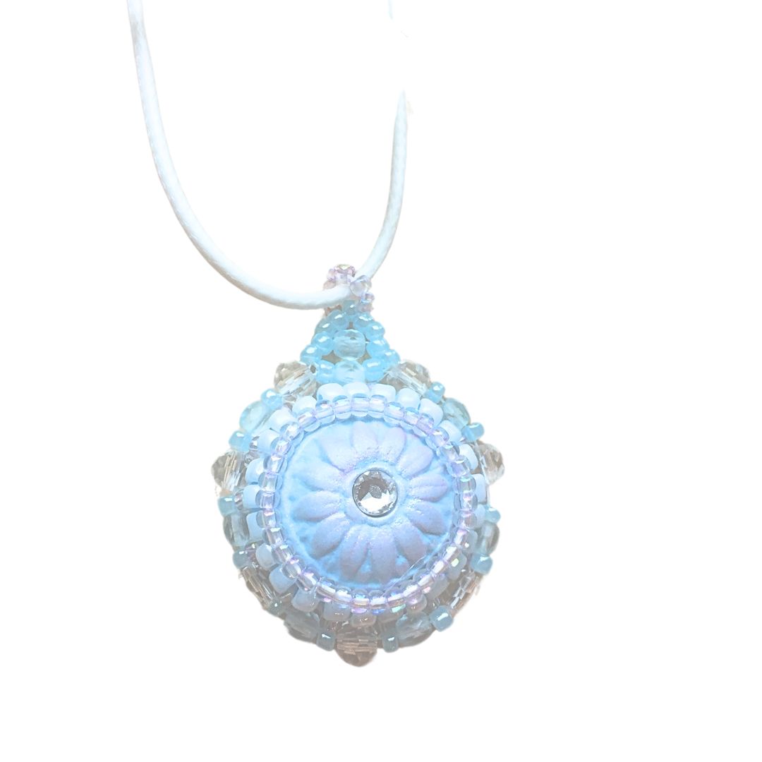 light blue flower necklace against a white background.