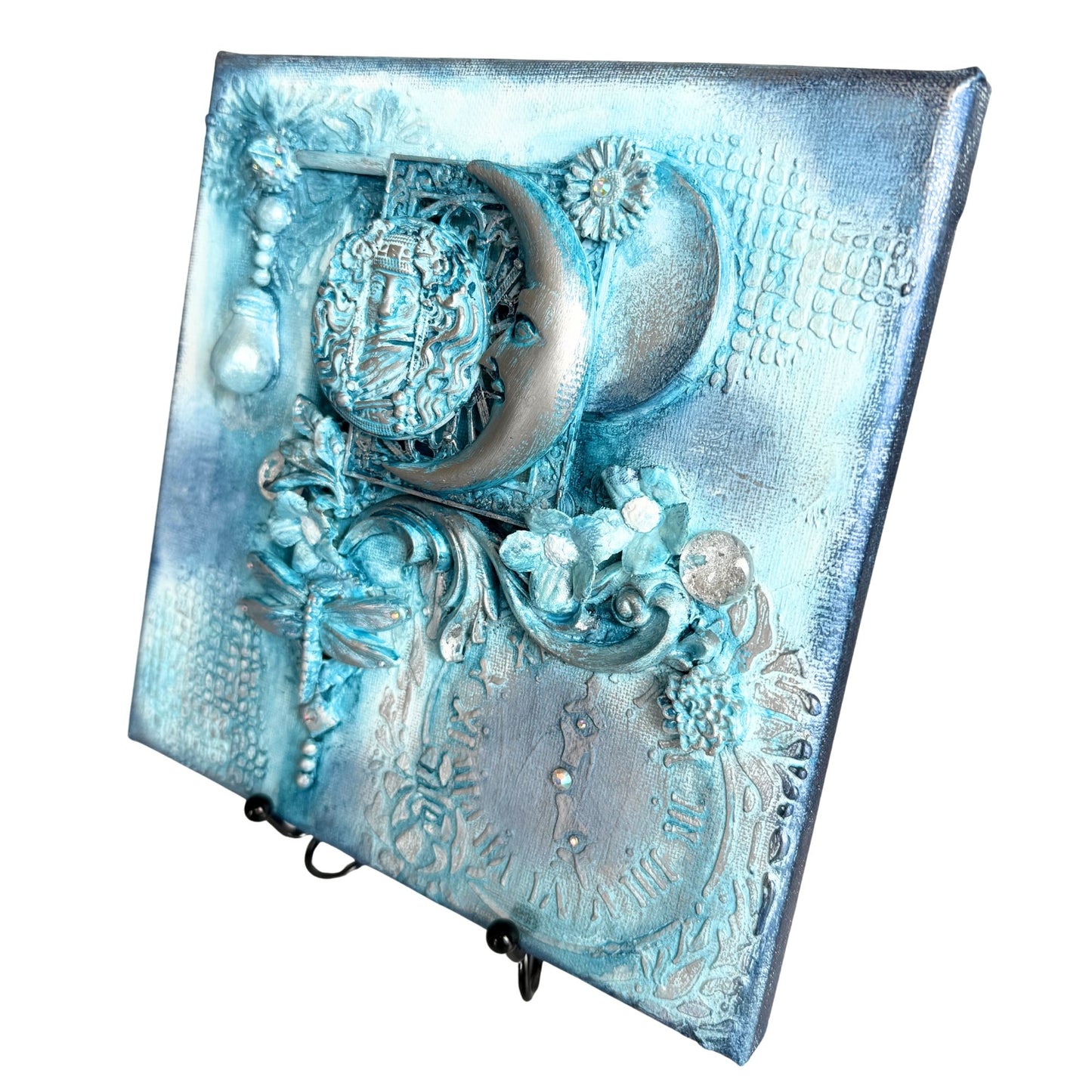 Decorative blue and silver wall art with intricate designs on a white background