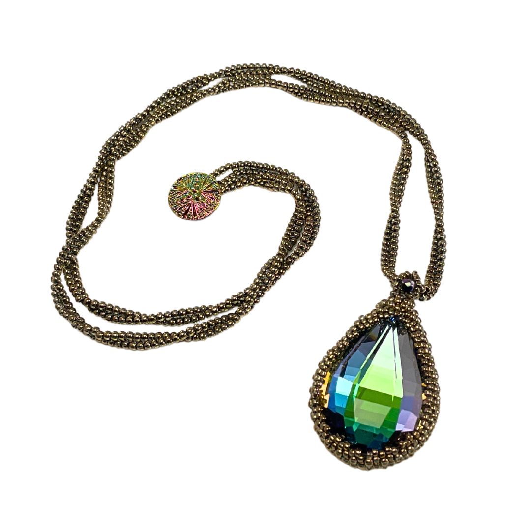 large beaded teardrop shaped rainbow crystal necklace with twisted beaded chain with an iridescent button closure.