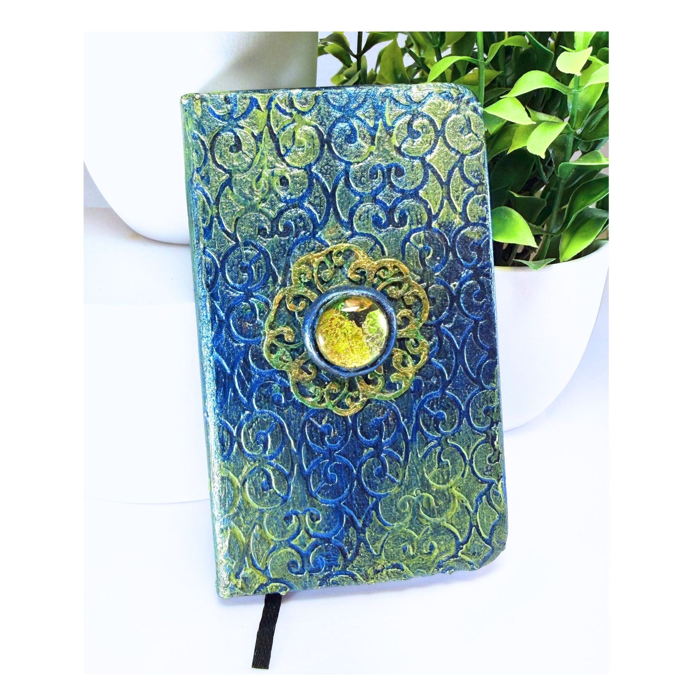 Decorative notebook with blue and green patterns on a white background