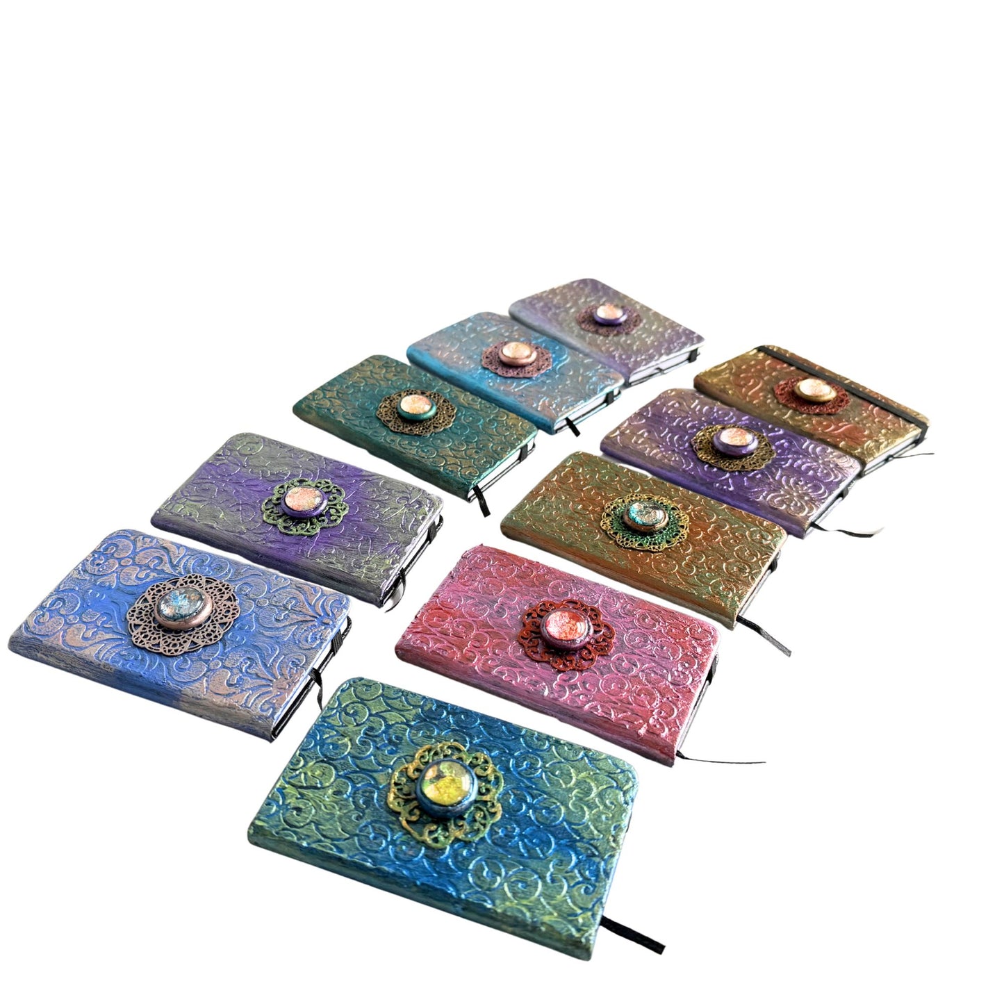 Set of colorful leather-bound journals with decorative elements on a white background
