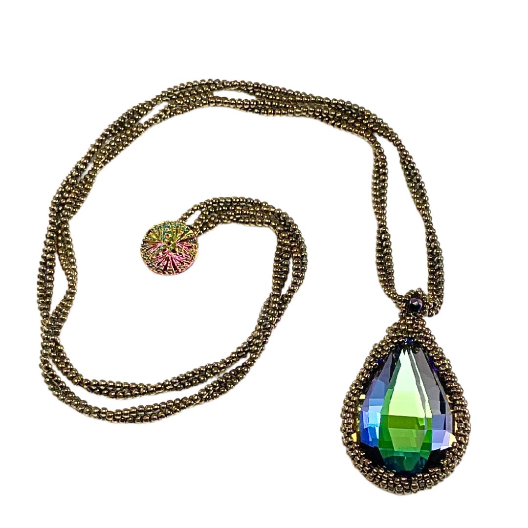 large beaded teardrop shaped rainbow crystal necklace with twisted beaded chain with an iridescent button closure.