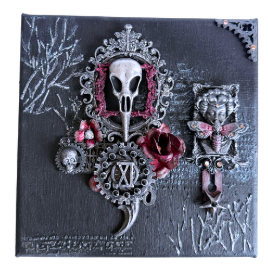Decorative piece with skull, roses, and intricate designs on a dark background