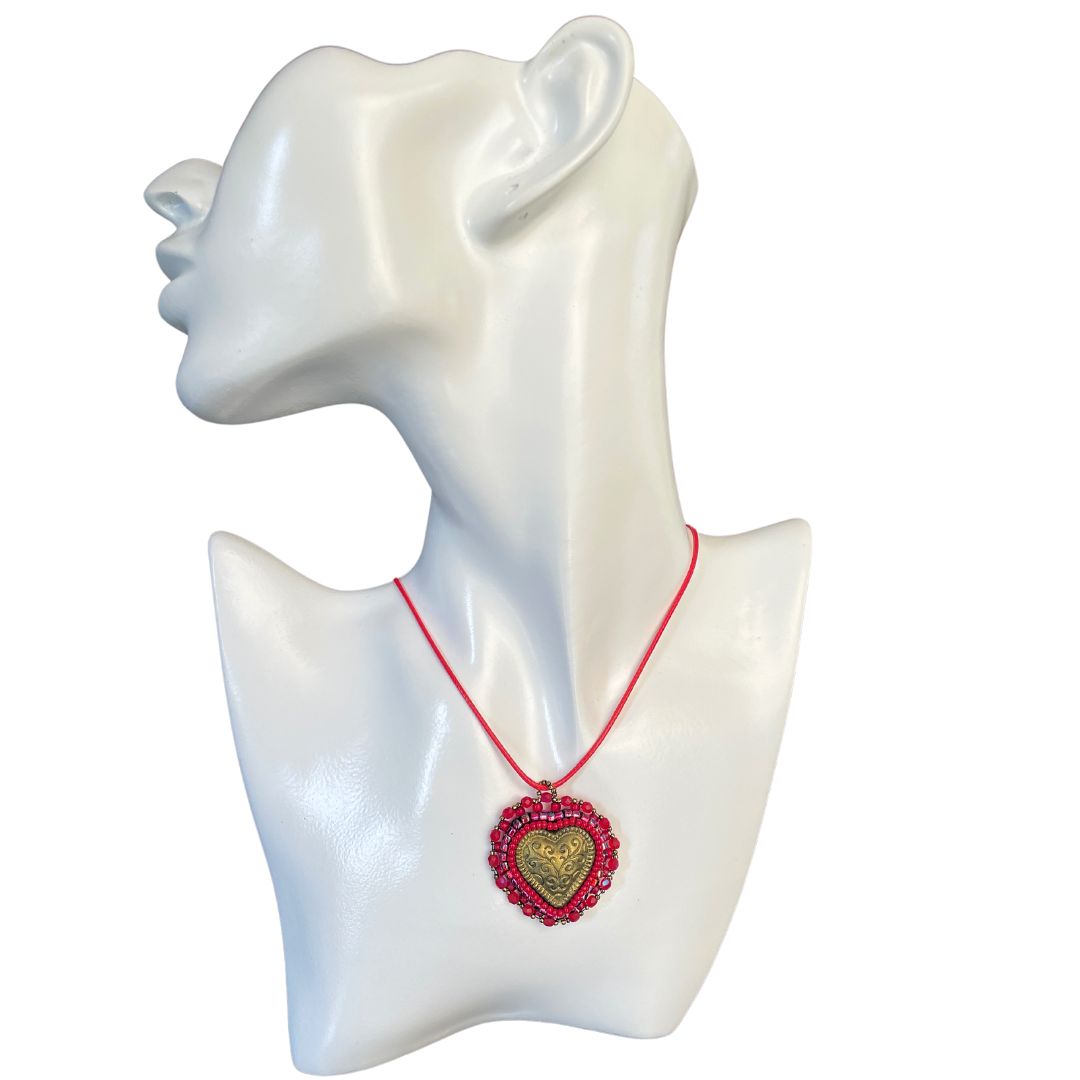 Gold puffed filigree heart red beaded pendant on model