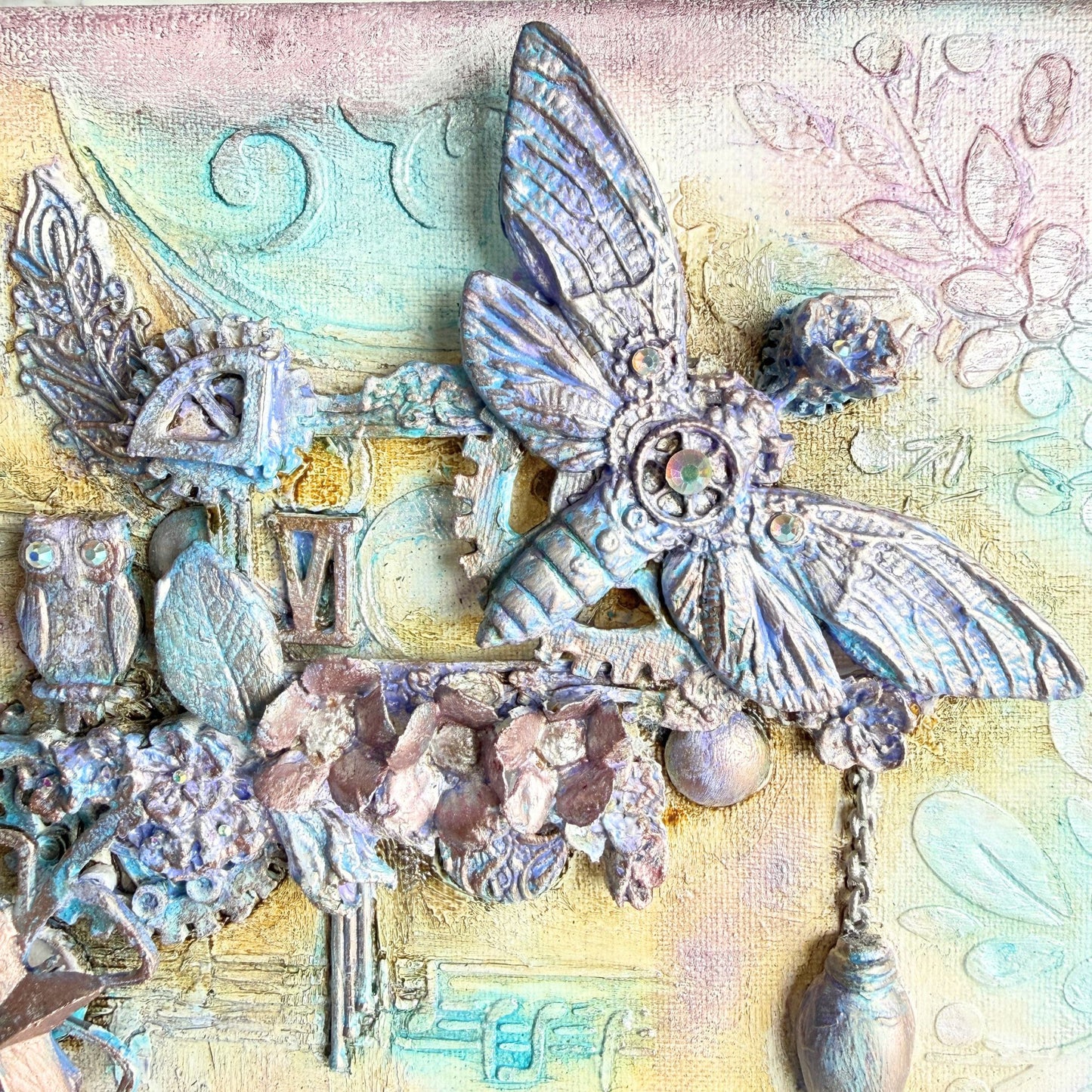 Decorative collage with butterfly, owl, and floral elements on a textured background