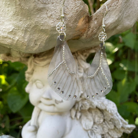 Silver beaded gray sheer fabric butterfly wing earrings with crystals and a flower bead connecting to the ear wires.