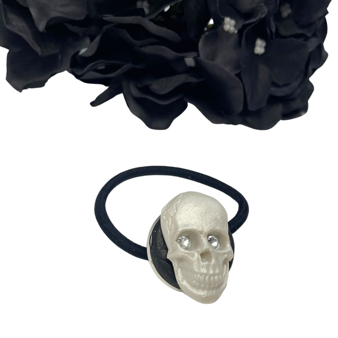 Decorative Hair tie with polymer clay Skull with crystal eyes on a white background with black hydrangeas