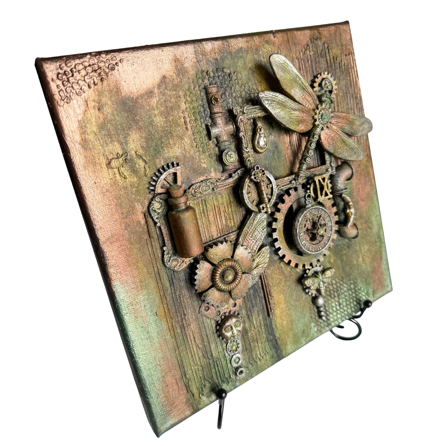 Decorative notebook with steampunk design featuring gears and a dragonfly on a textured cover.
