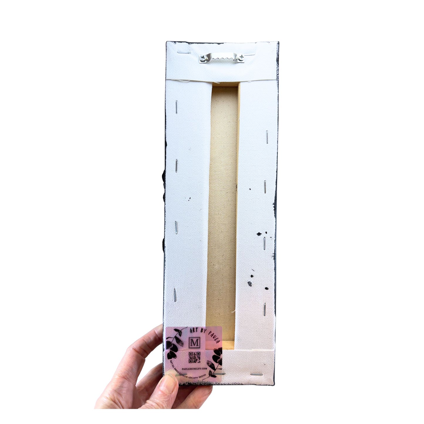 Hand holding a rectangular product packaging with a white background