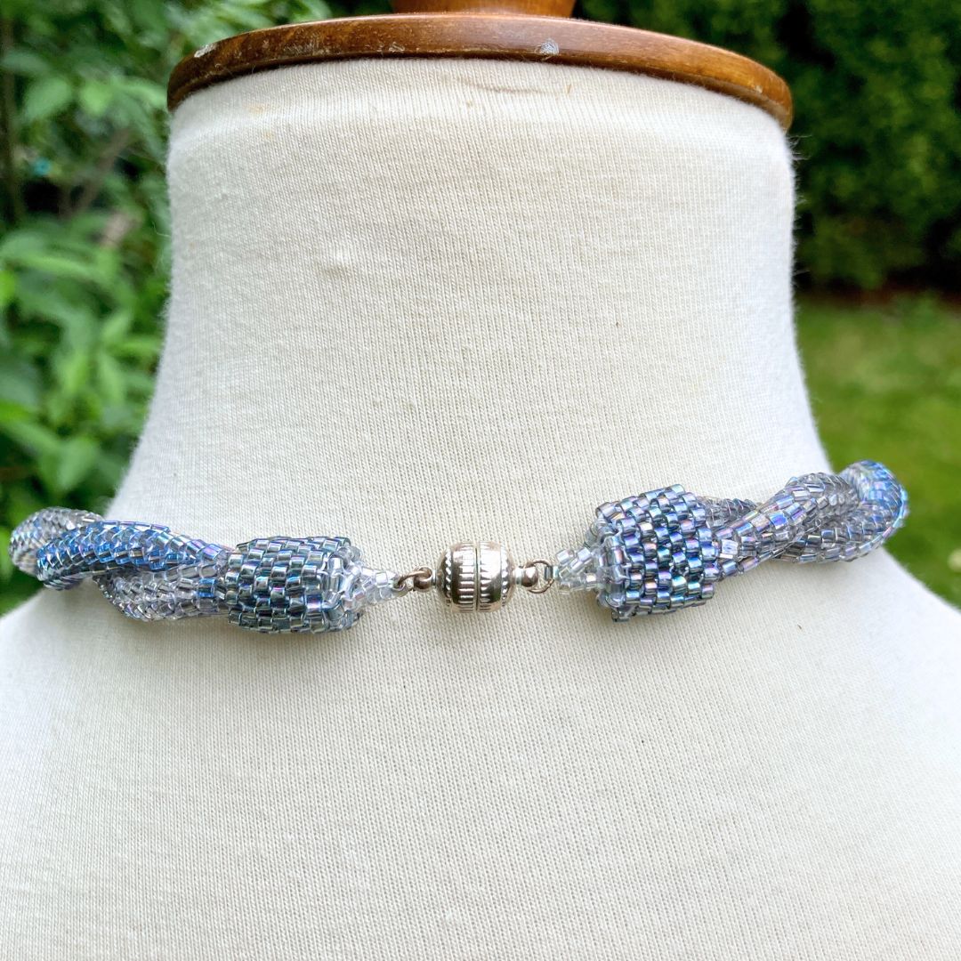 Back of Beaded rope necklace on a model in a garden setting