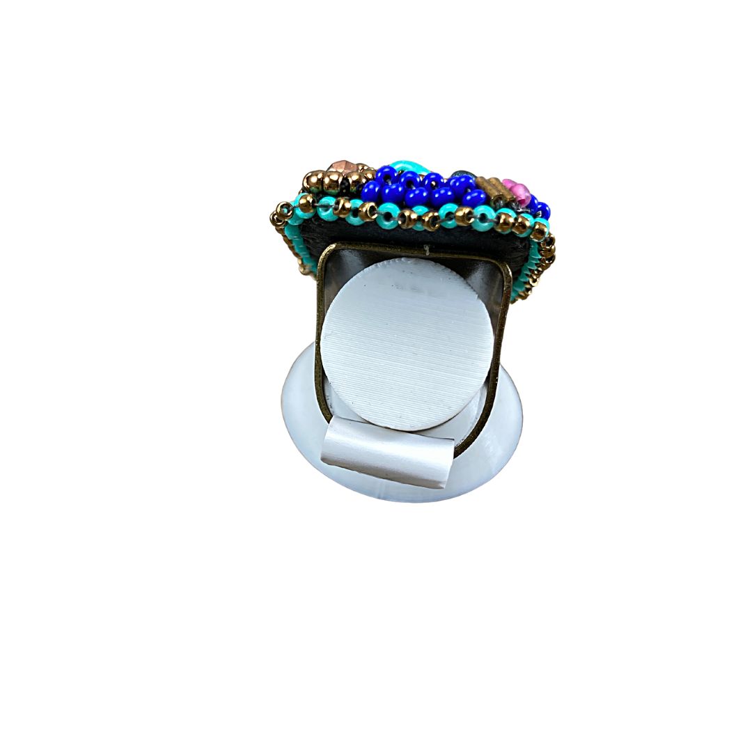 Back view of Hand beaded rectangle ring with pink and turquoise flower with bronze crystals and with gold and royal blue glass bead details.