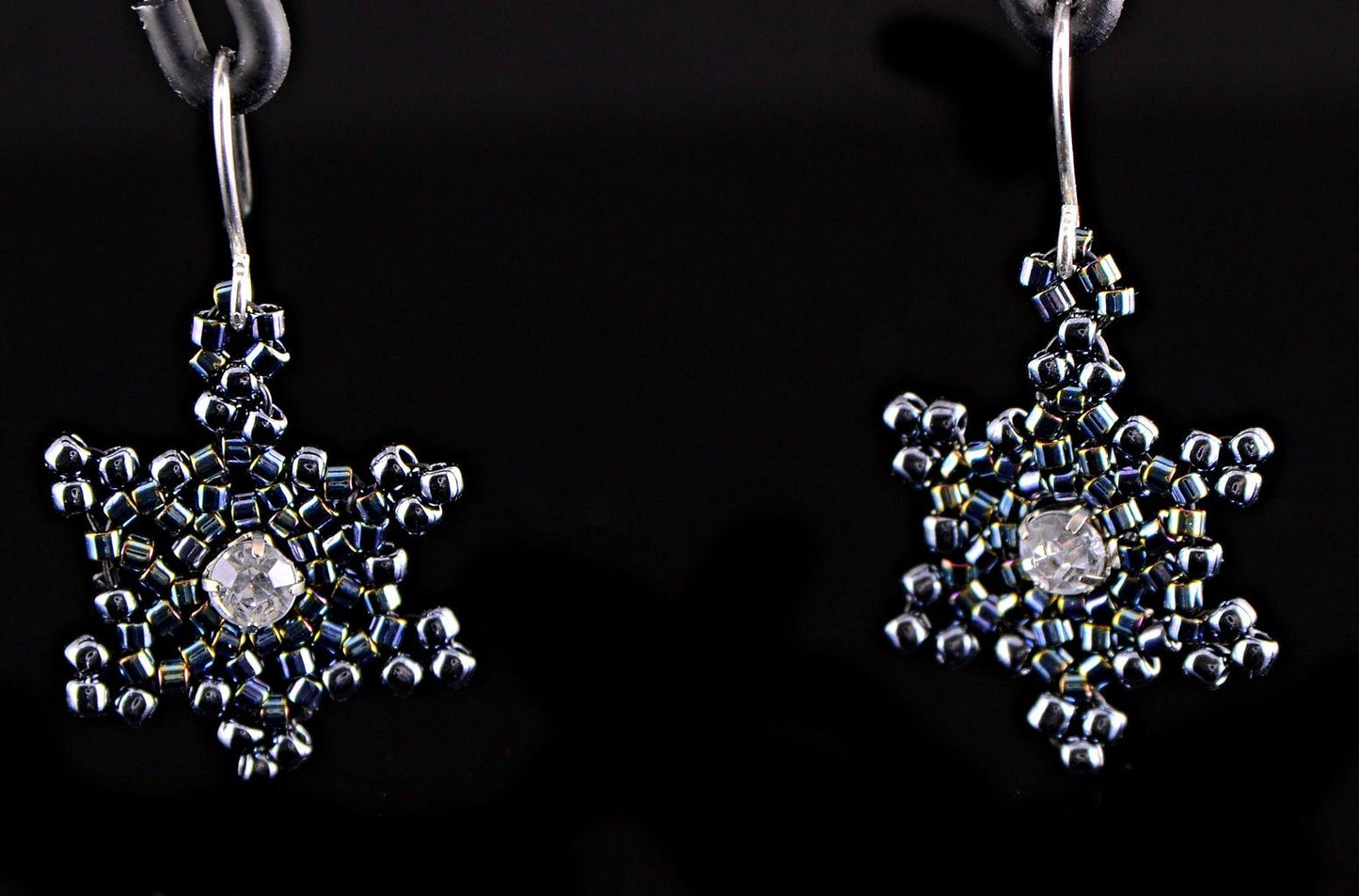 Black gothic snowflake earrings close up view