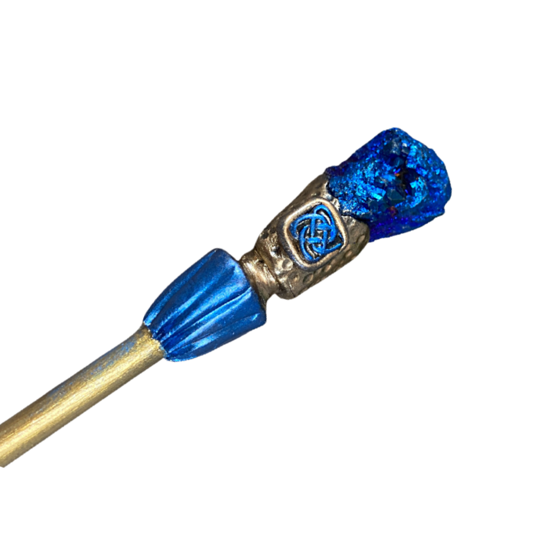Wood hair stick with metallic blue druzy crystal at one end and polymer clay Celtic knot detail in gold and blue clay.