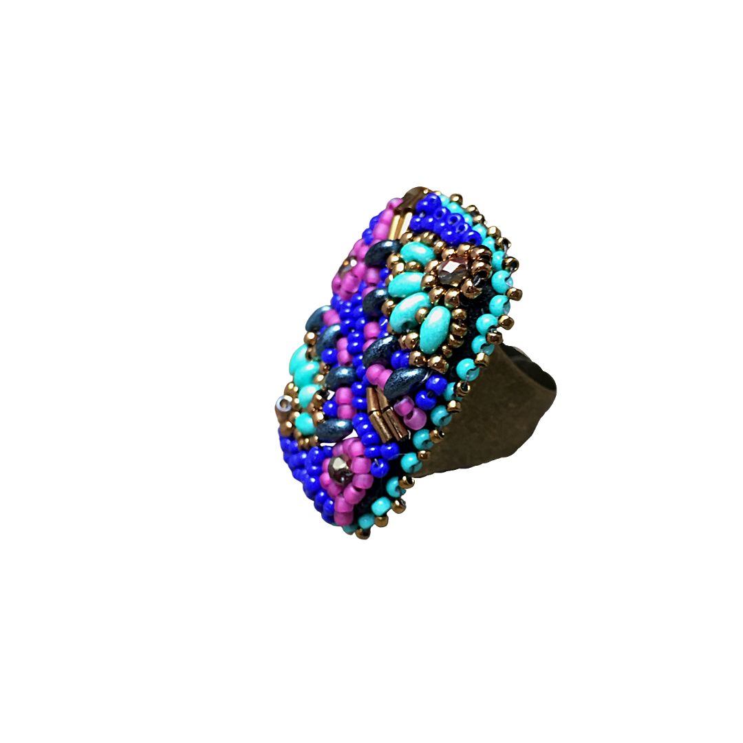 Side view of Hand beaded rectangle ring with pink and turquoise flower with bronze crystals and with gold and royal blue glass bead details.