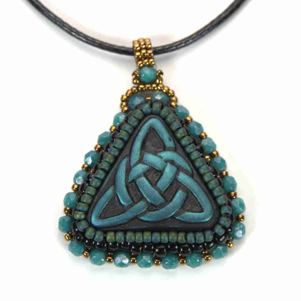 Blue celtic trinity knot pendant with turquoise and gold bezel and bail