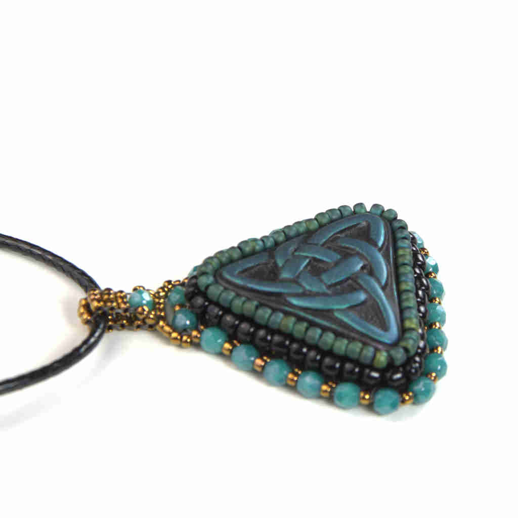 Blue celtic trinity knot pendant with turquoise and gold bezel and bail