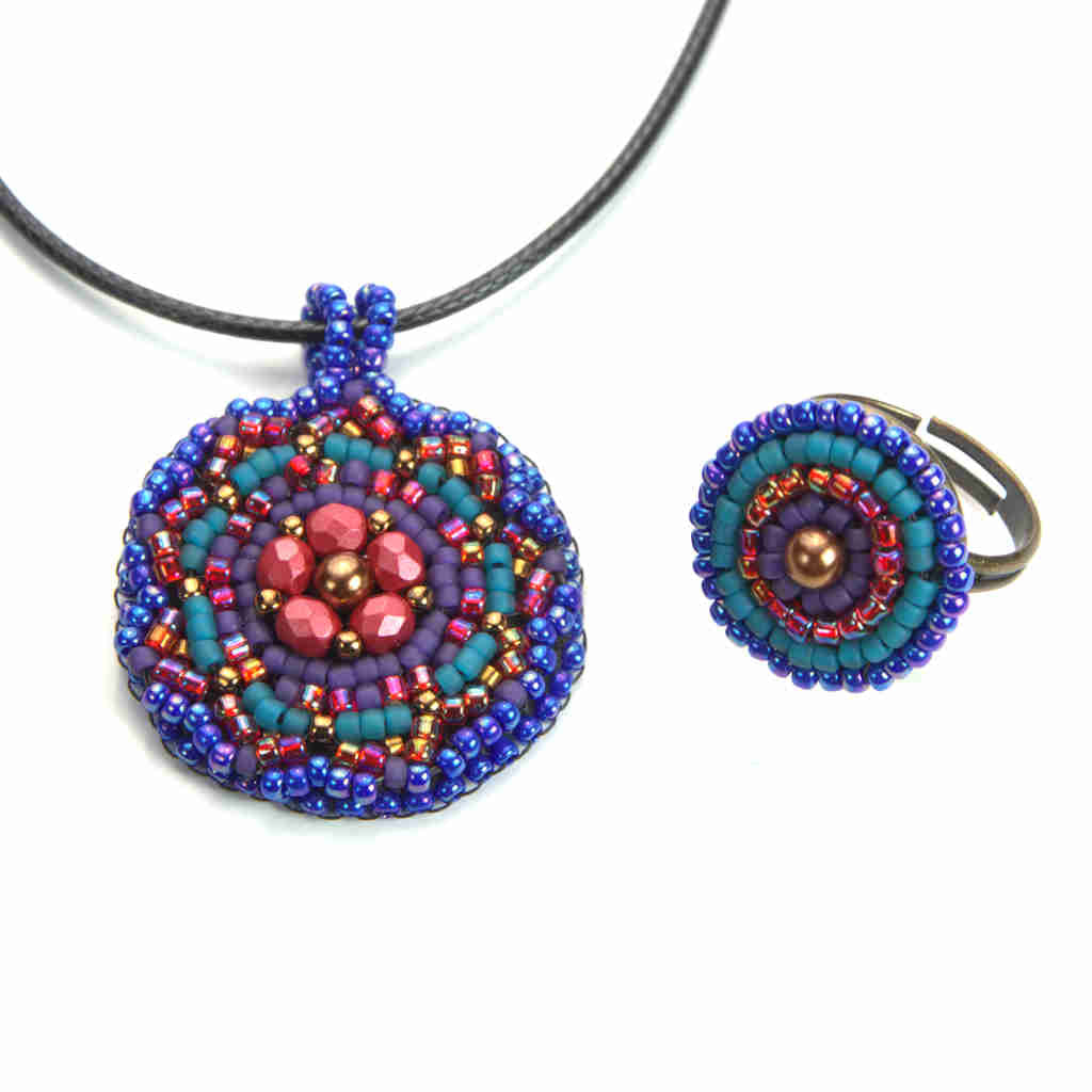 Mandala pendant and ring set in vibrant blue, raspberry, and gold