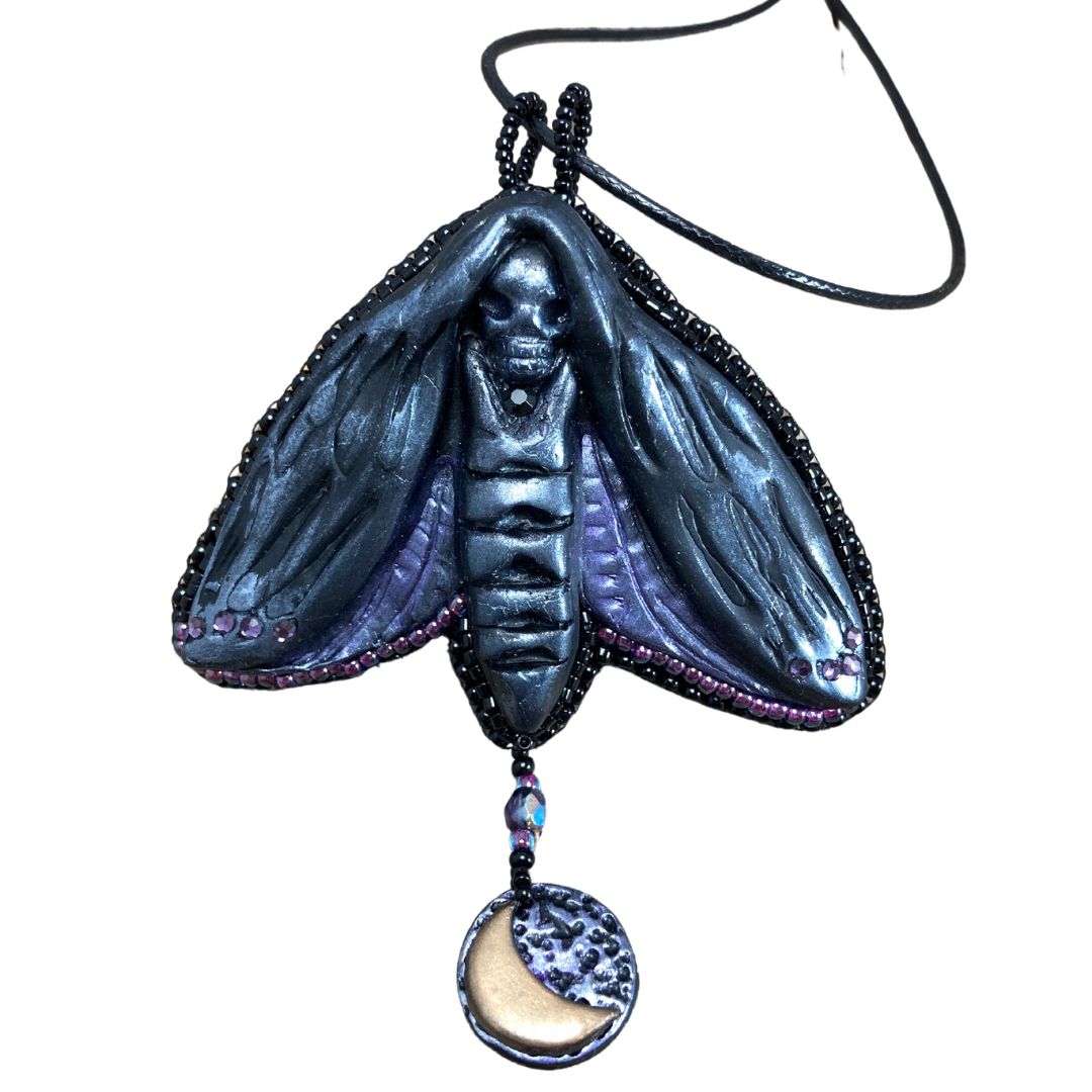 Silver and purple Death Head Moth pendant made with black polymer clay with a round charm with a crescent moon.