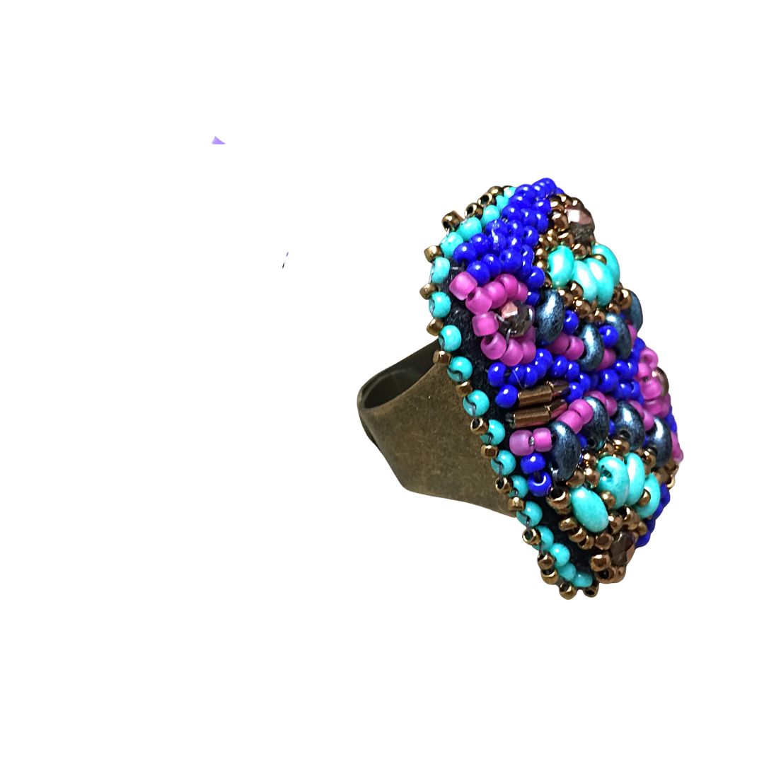 Side view of Hand beaded rectangle ring with pink and turquoise flower with bronze crystals and with gold and royal blue glass bead details.