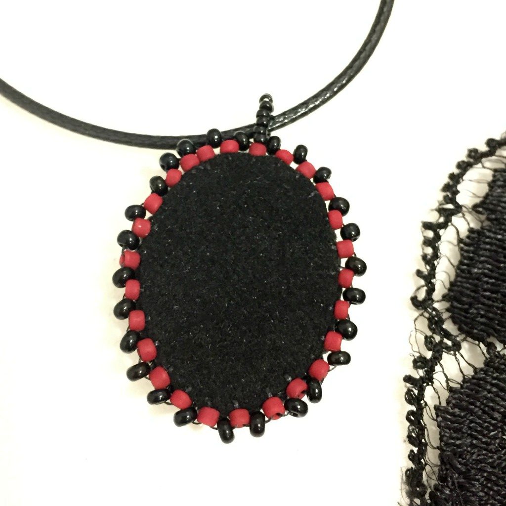 back of skull raven and rose pendant