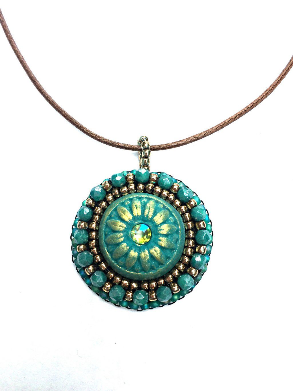 Tidy green and gold daisy pendant with crystal center stone