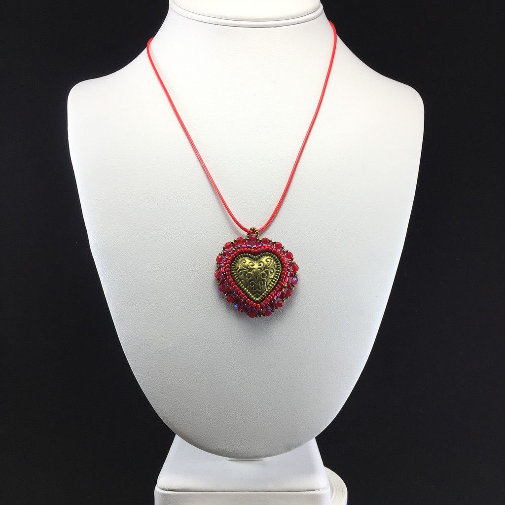 gold heart pendant with red beading