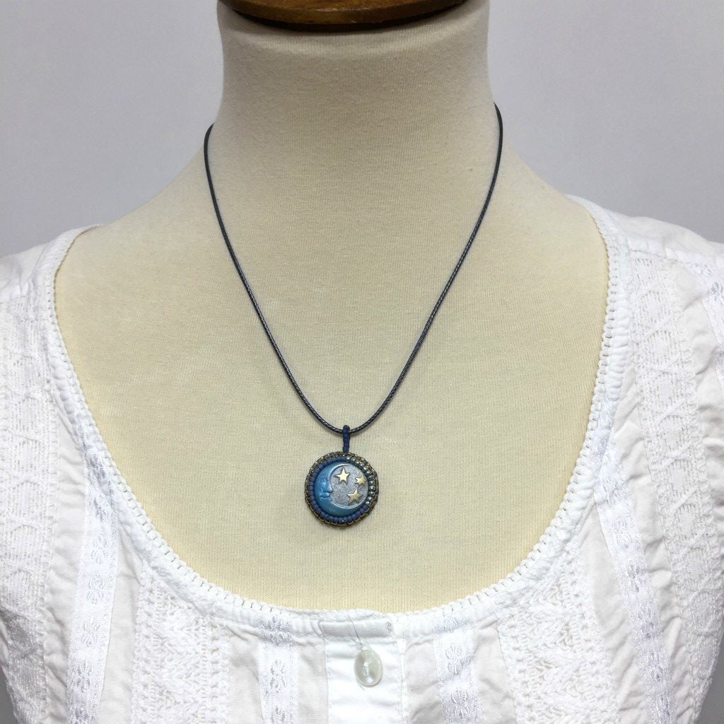 sun and moon necklace on mannequin
