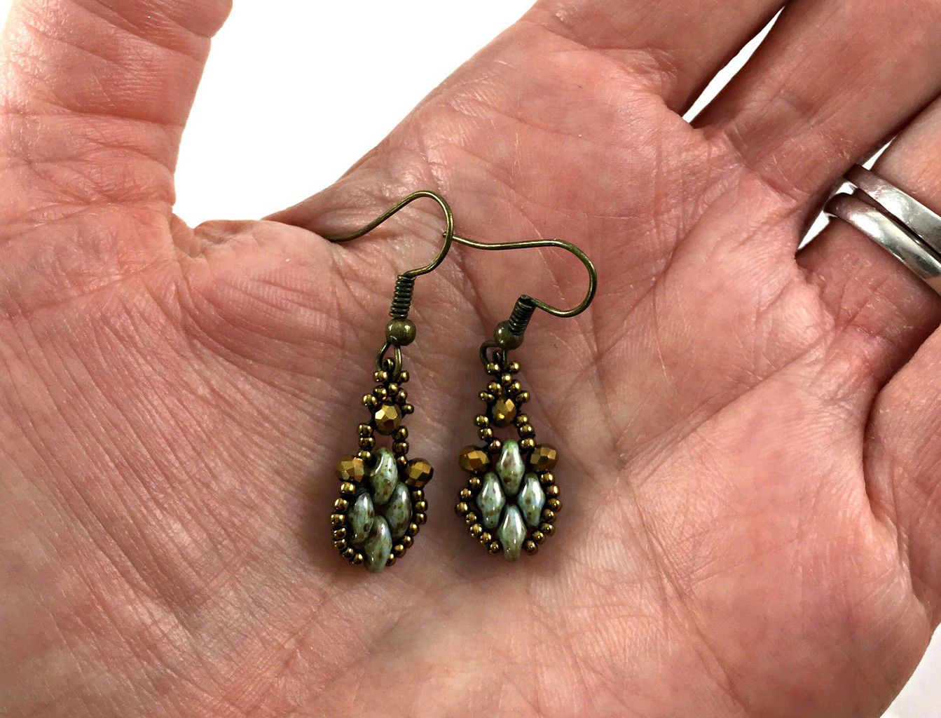Green Victorian style drop earrings detail view