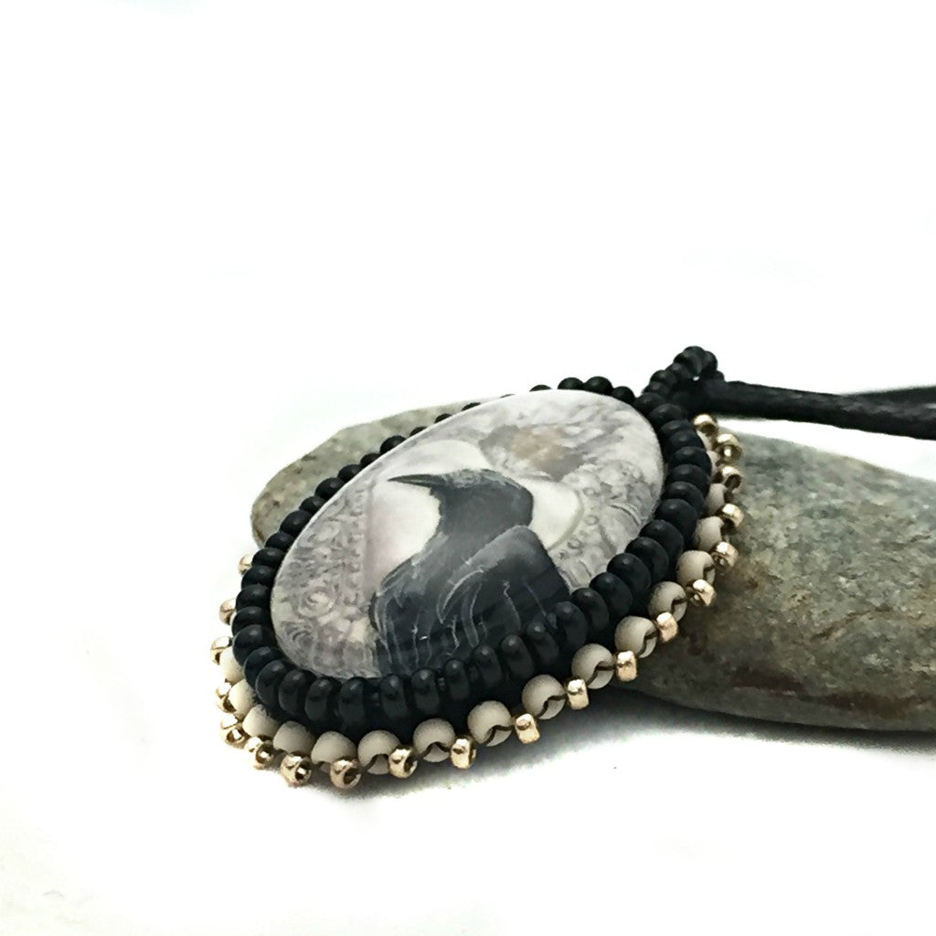 left side of raven art necklace