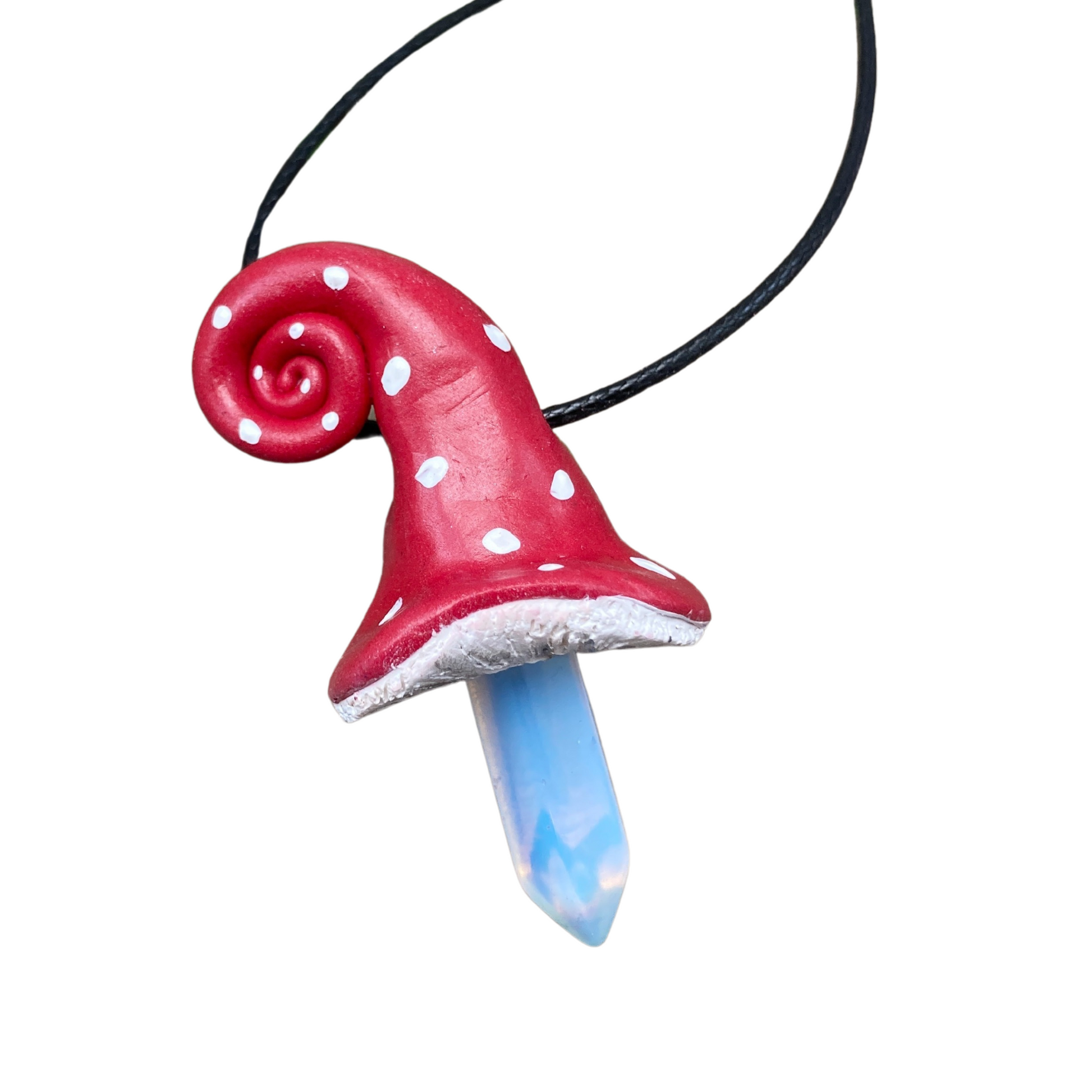 White spotted red mushroom sculpted with polymer clay with an Opalite crystal point on a black cord necklace