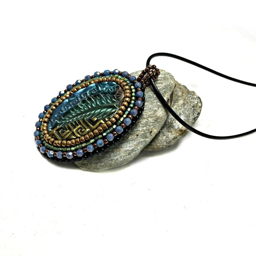 Left side view of zentangle art pendant with blue crystals