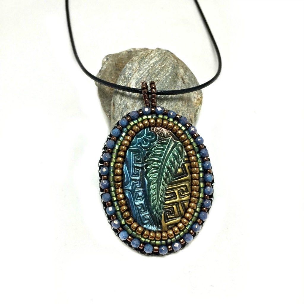 zentangle art pendant with blue crystals distance shot