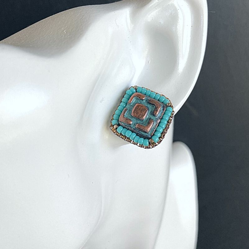 Turquoise beaded aztec stud earrings with patina geometric pattern
