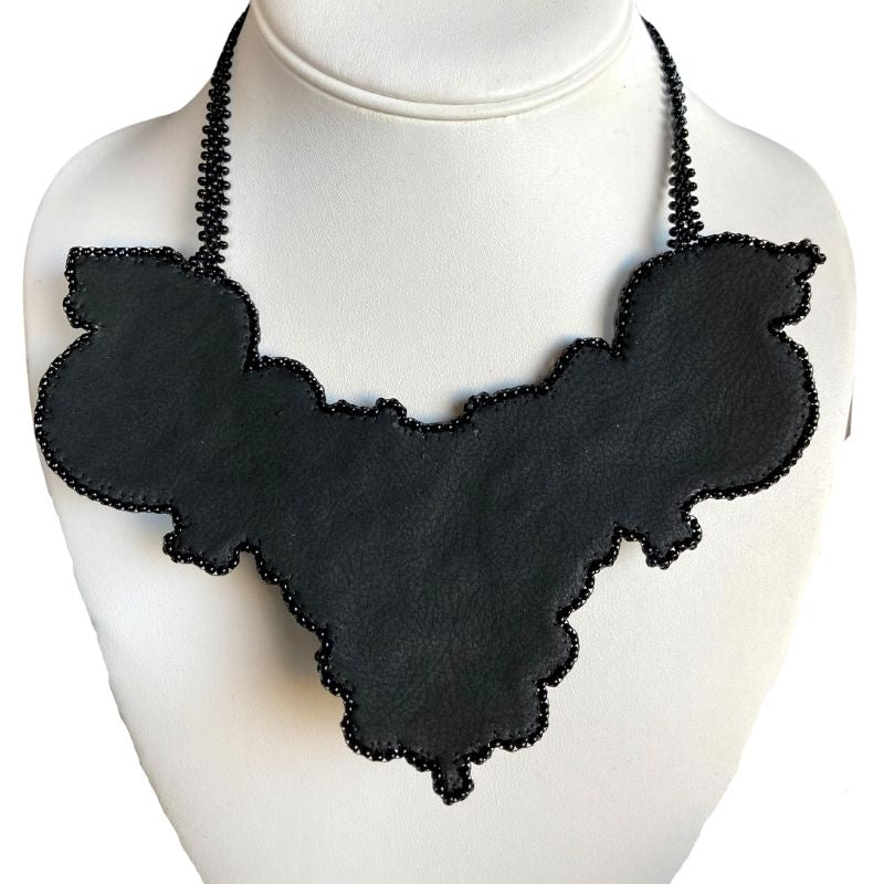 Back of of gothic bib necklace with faux leather