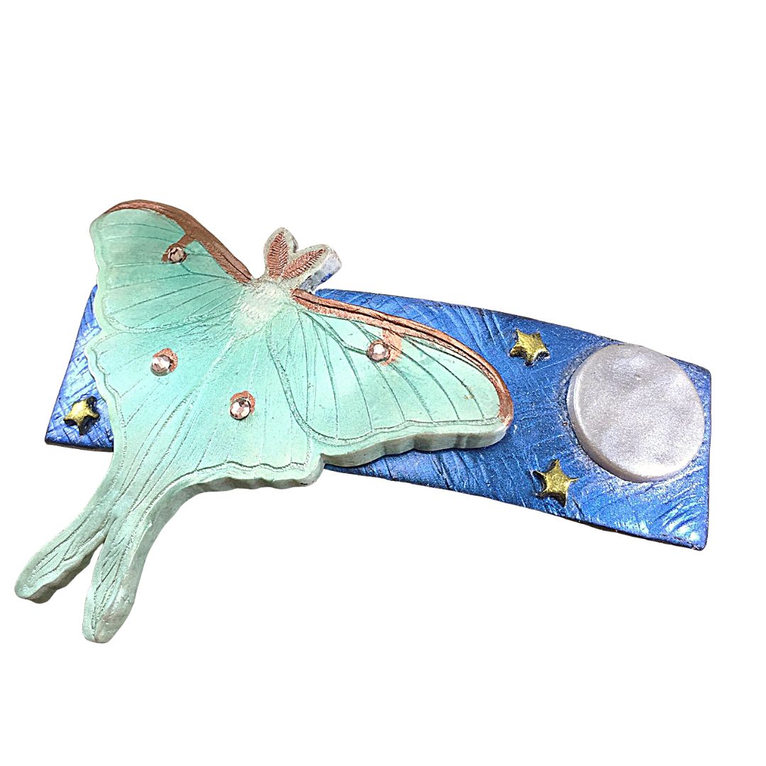 Polymer clay green giant silk moth on blue base with moon and stars hair clip.