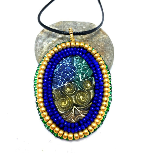 Blue and gold zentangle pattern pendant