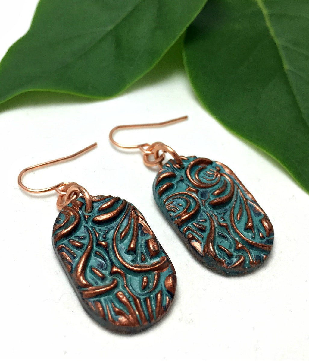 Side view of floral patina earrings