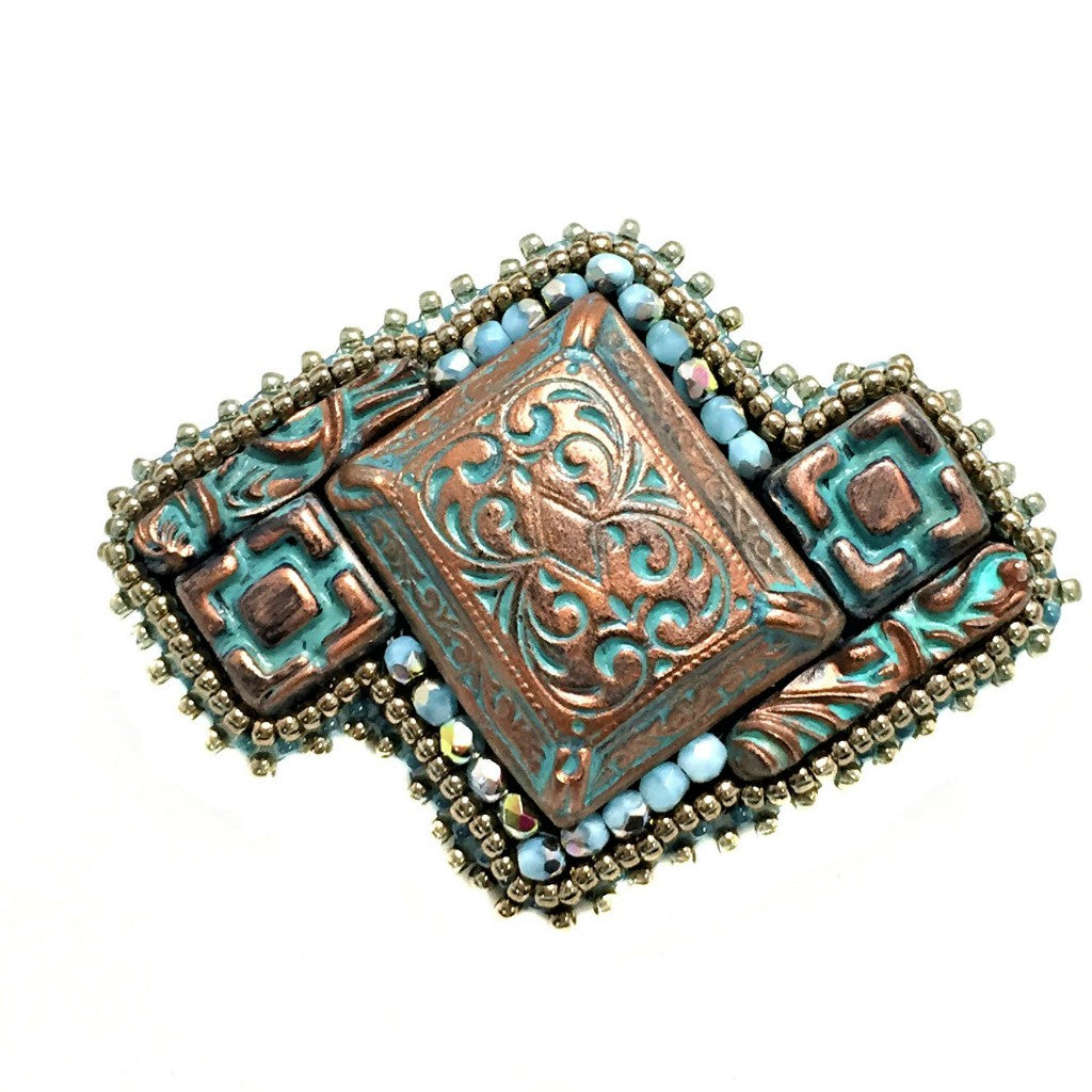 copper patina brooch